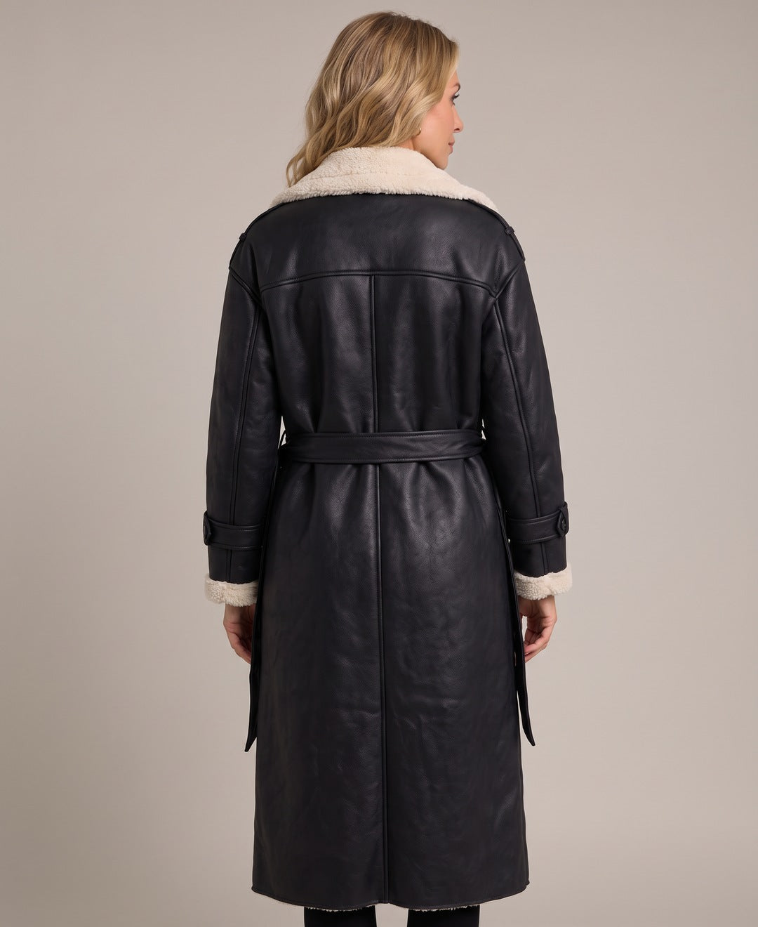 Black long faux leather coat with teddy lining, back view on model
