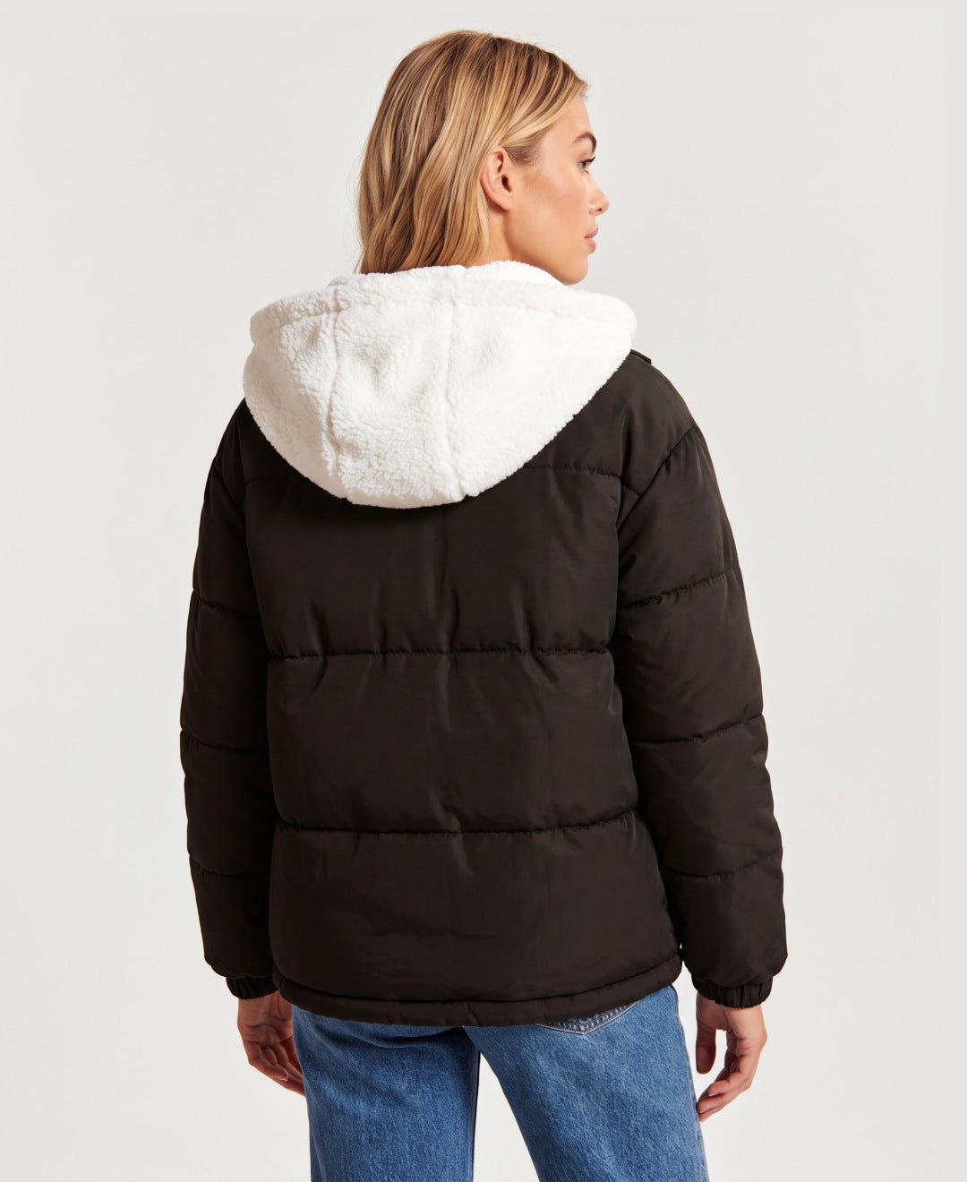 Women's hooded puffer jacket with sherpa fleece hood in black, back view