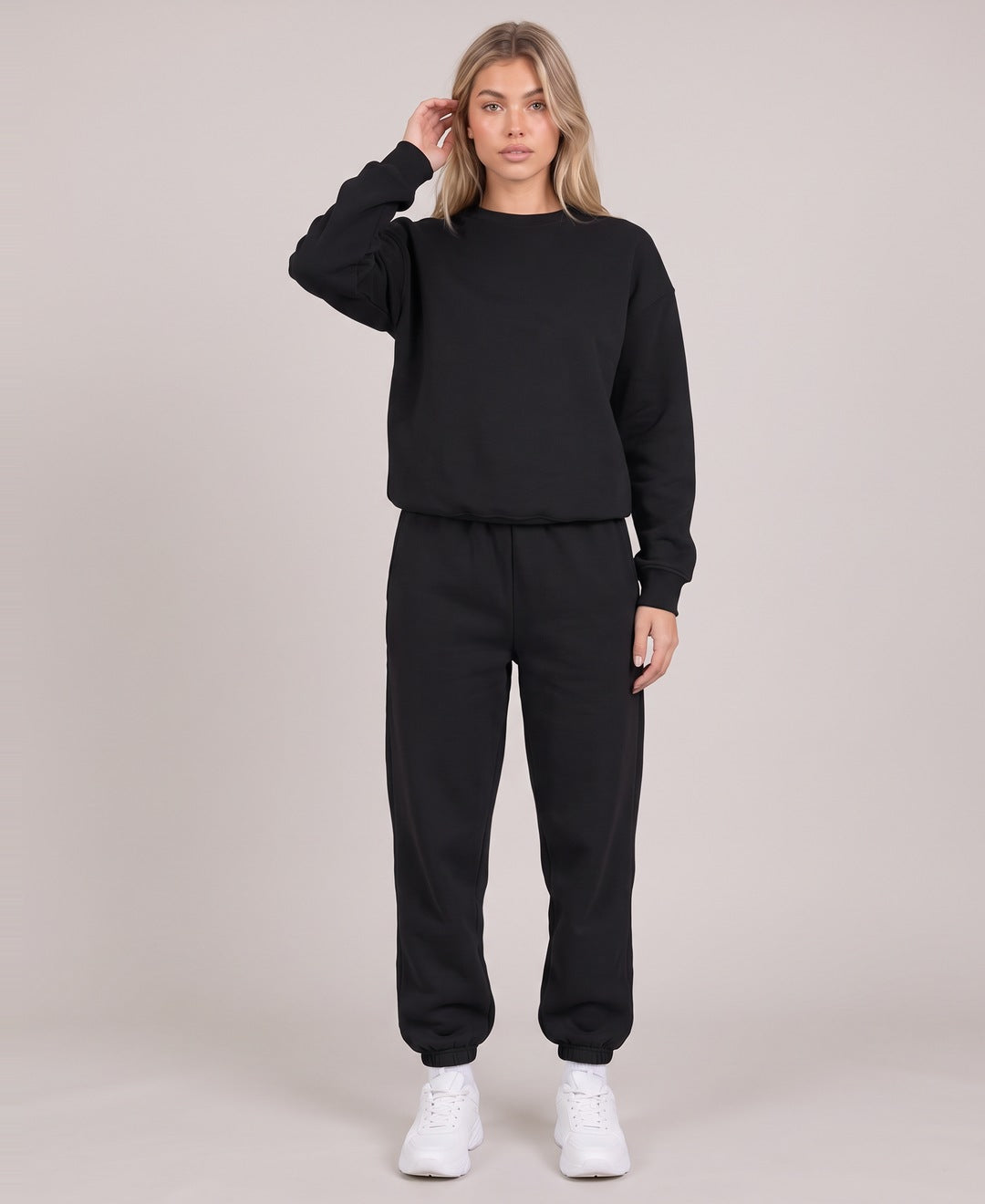 Black crew neck sweatshirt and joggers set front view on model