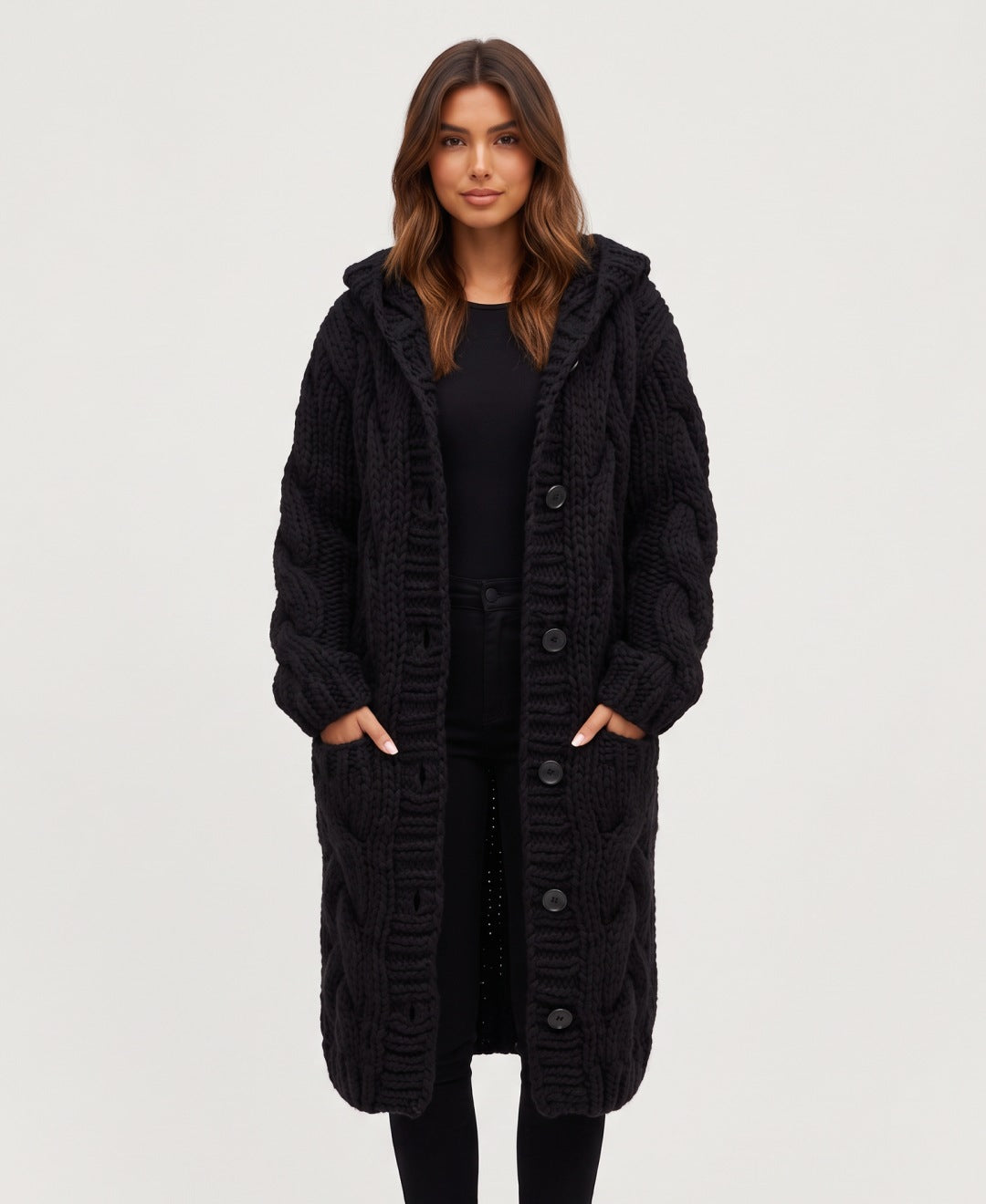 Women's long chunky cable knit hooded cardigan in black, front view