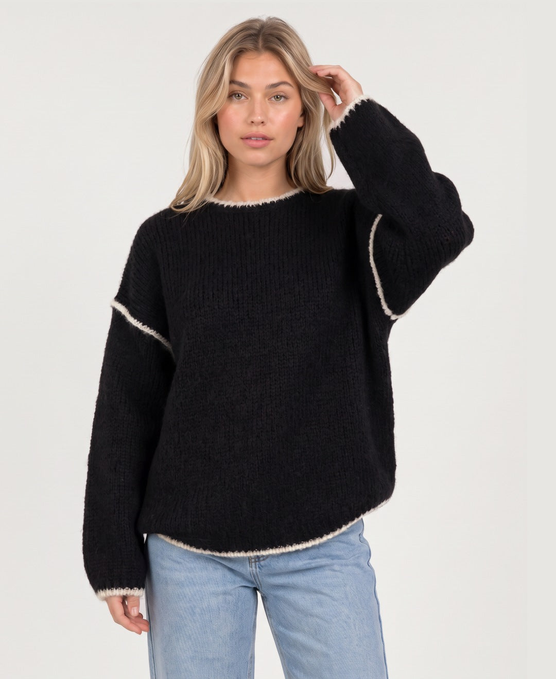 Women's oversized crew neck knit jumper with contrast edging in black, front view