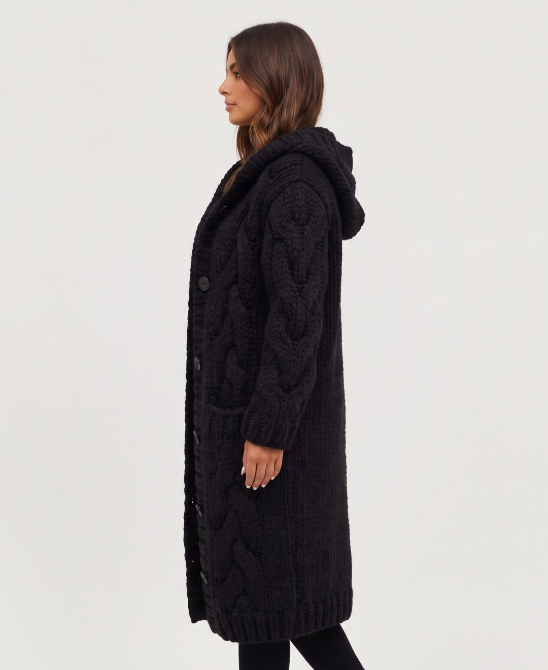 Women's long chunky cable knit hooded cardigan in black, side view