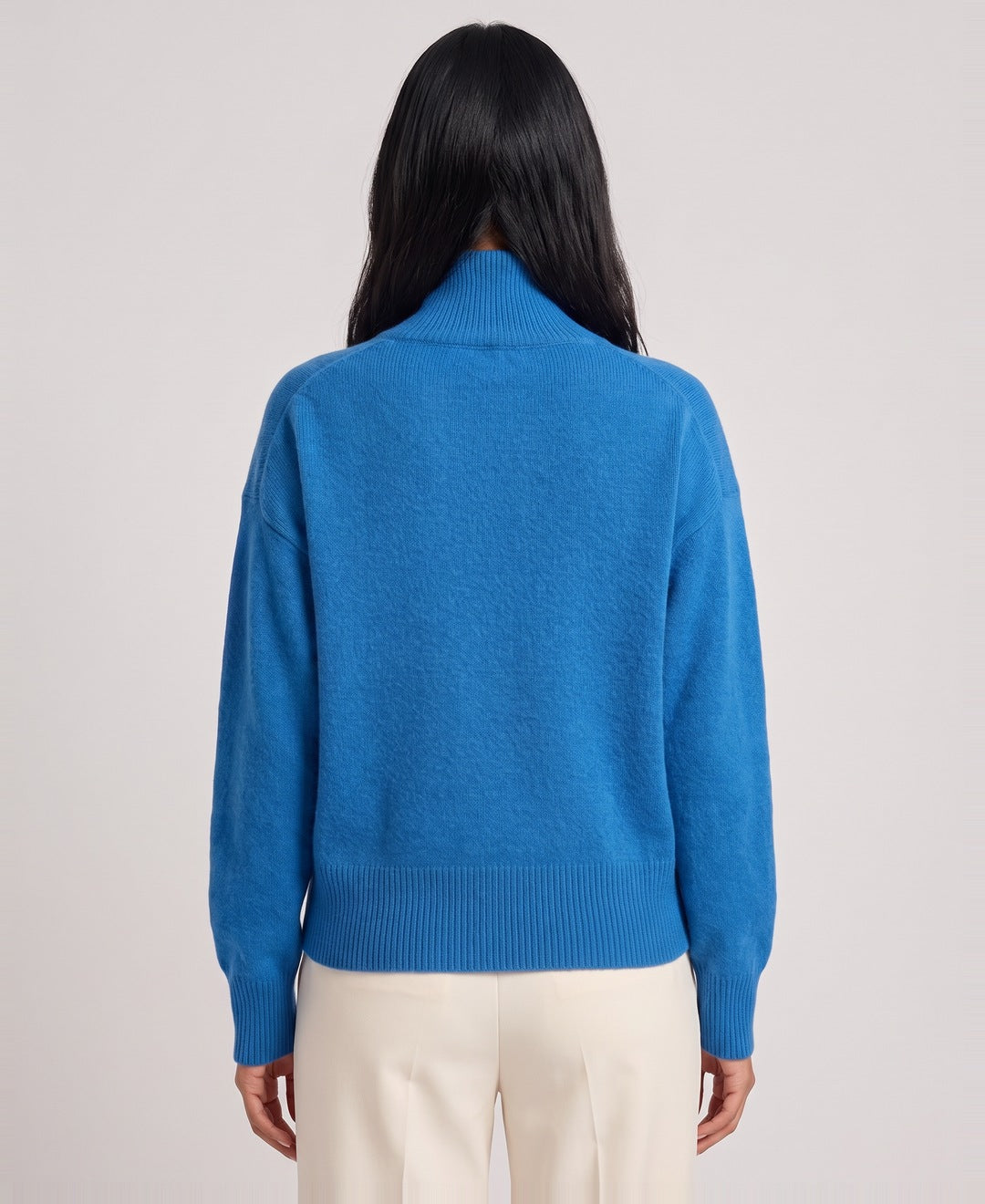 Blue roll neck jumper back view on model