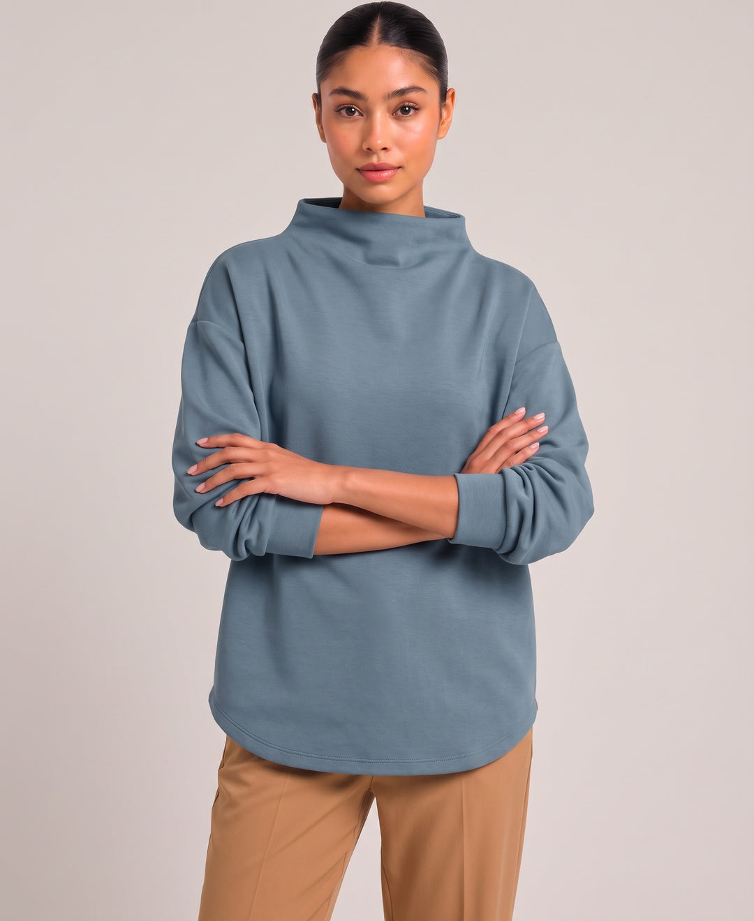 Women's oversized funnel neck top in blue, front view