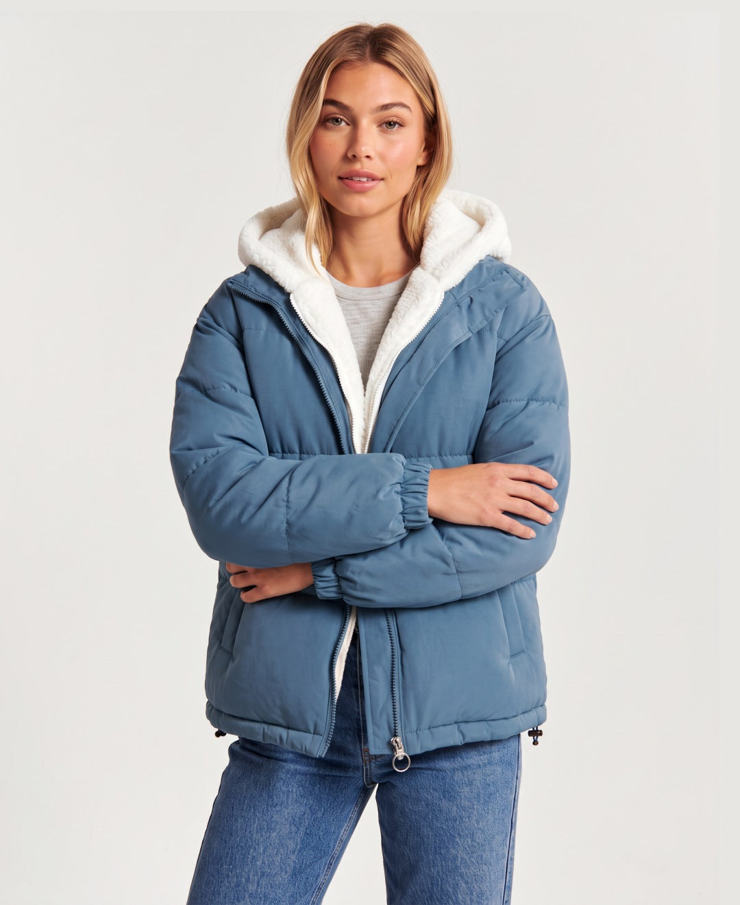 Women's hooded puffer jacket with sherpa fleece hood in blue, front view