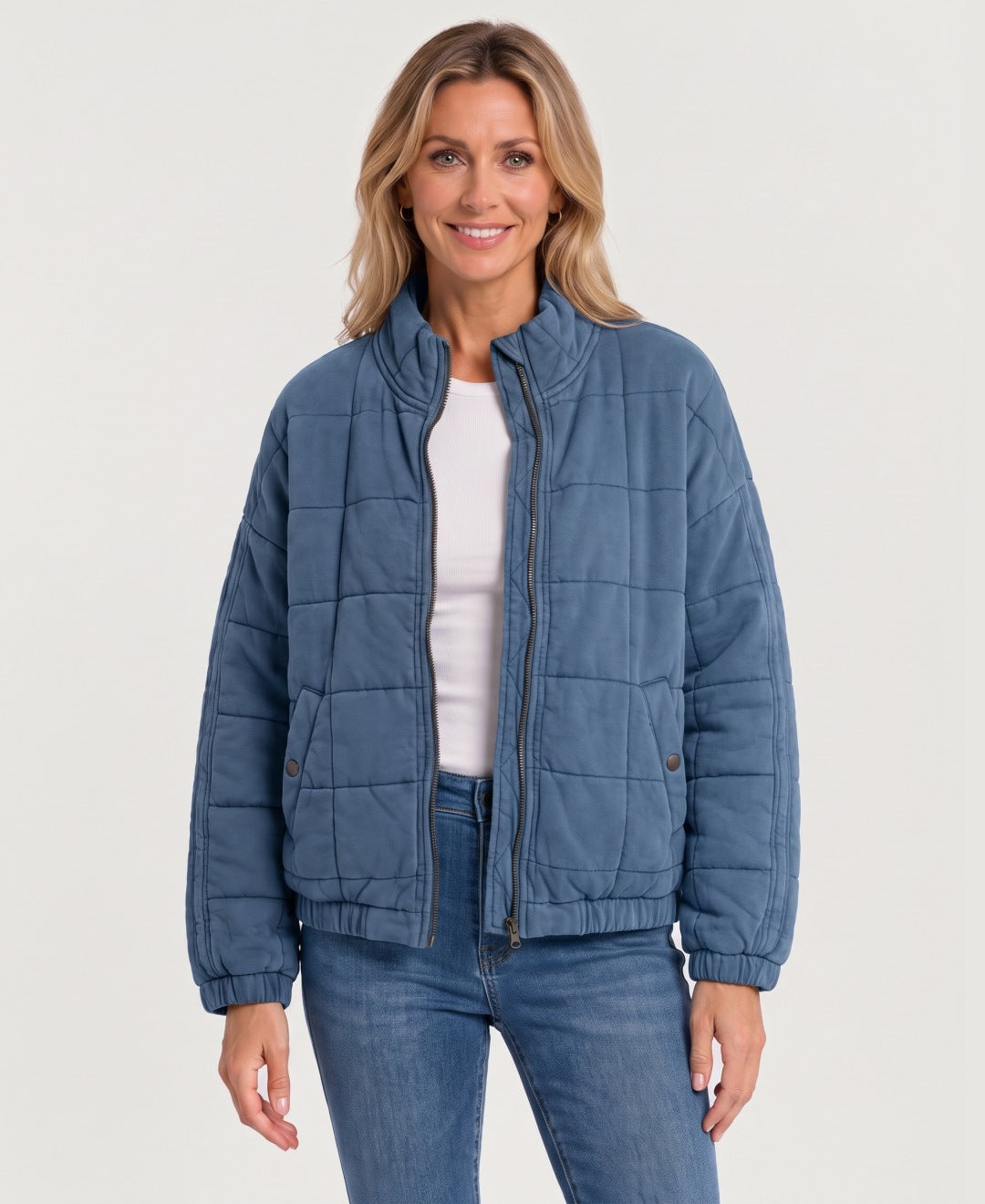 Women's quilted zip-up jacket blue front view