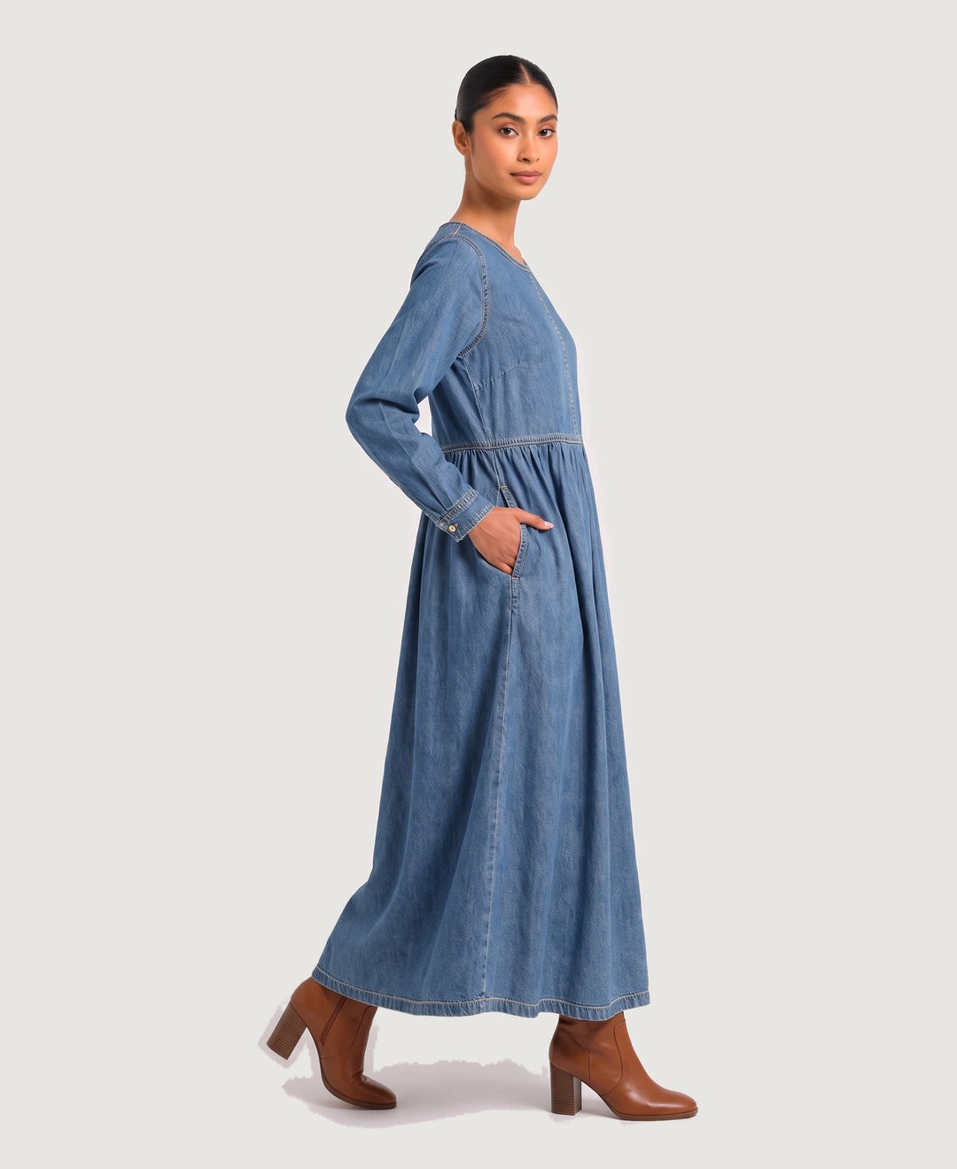 Women's long sleeve denim maxi dress in blue, side view