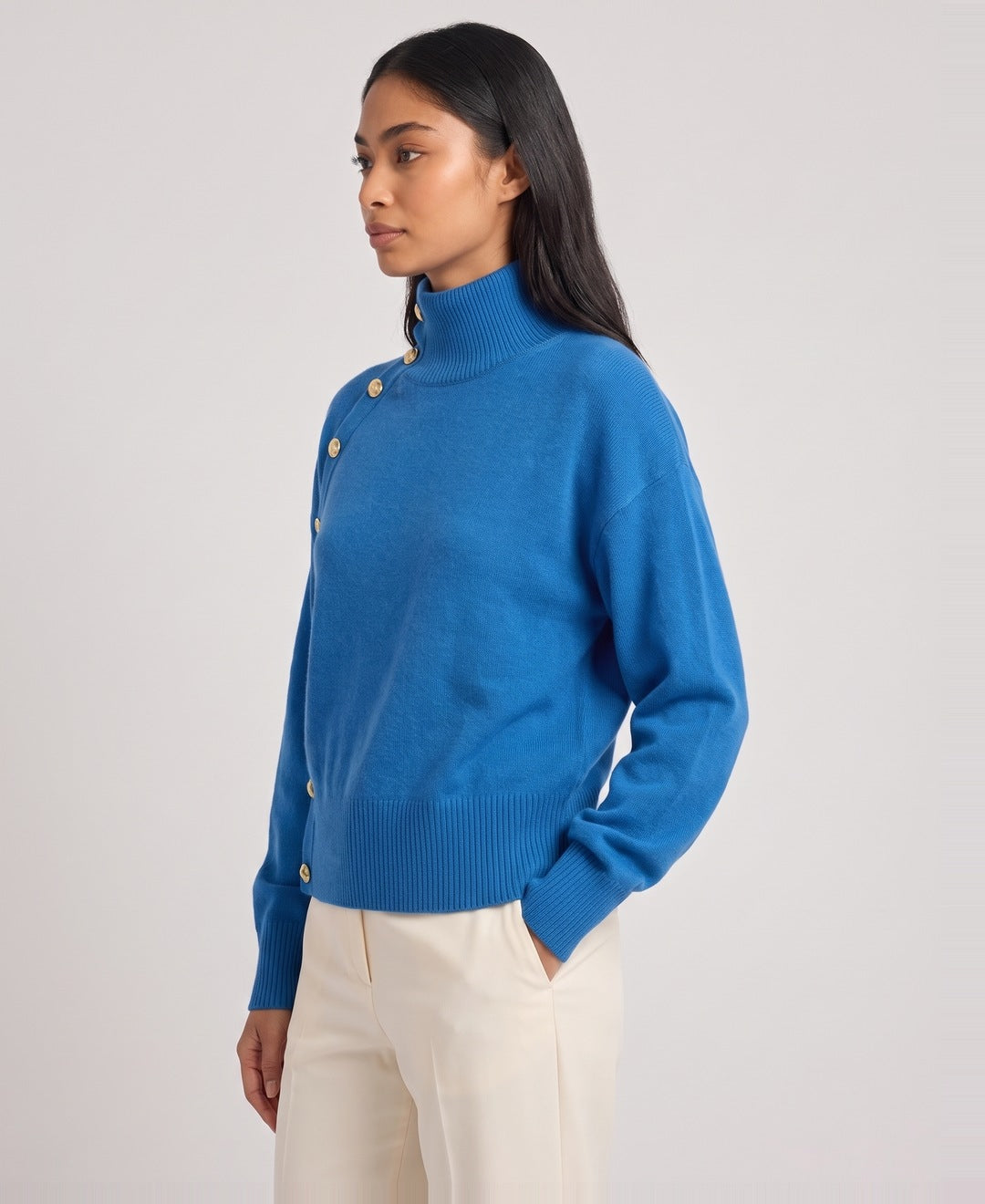 Blue roll neck jumper side view on model