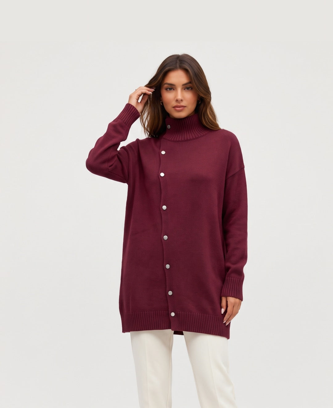 Women's longline roll neck jumper with asymmetric buttons in burgundy, front view