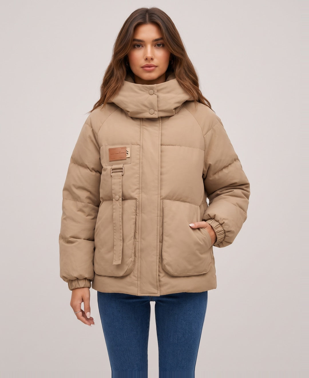 Camel oversized hooded puffer jacket front view on model