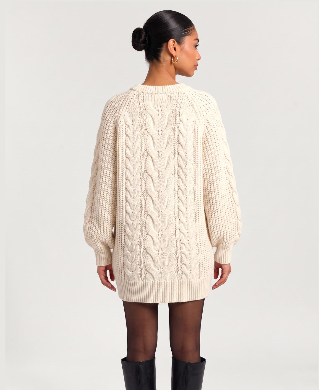Women's chunky cable knit jumper dress in cream, back view