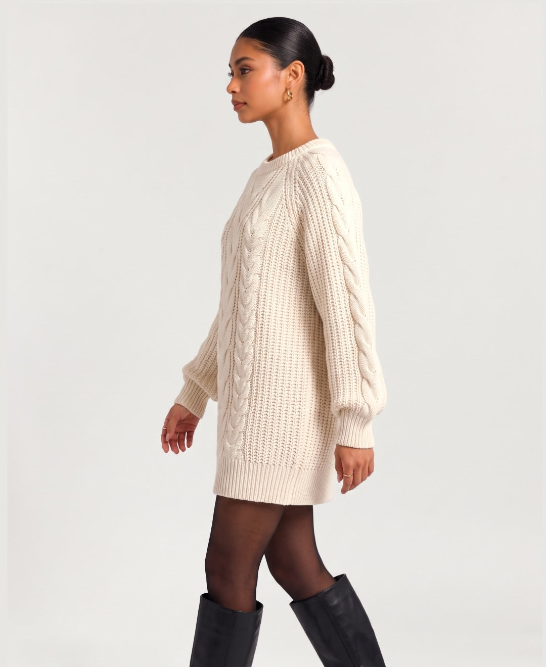 Women's chunky cable knit jumper dress in cream, side view