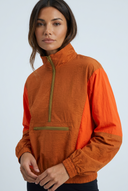 Orange colourblock half-zip windbreaker jacket closeup