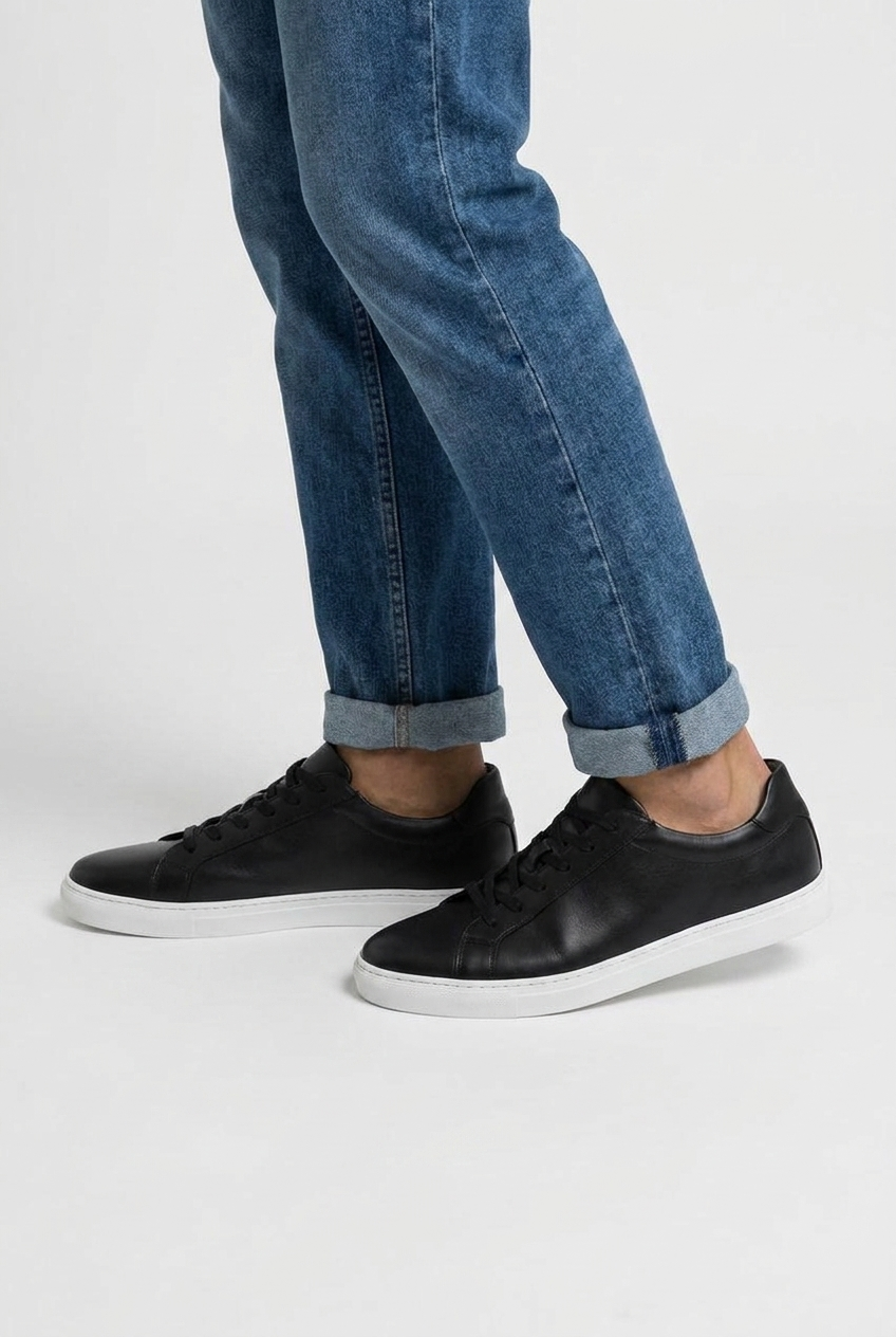 Carter men's minimalist leather-look low-top trainers in black, side view