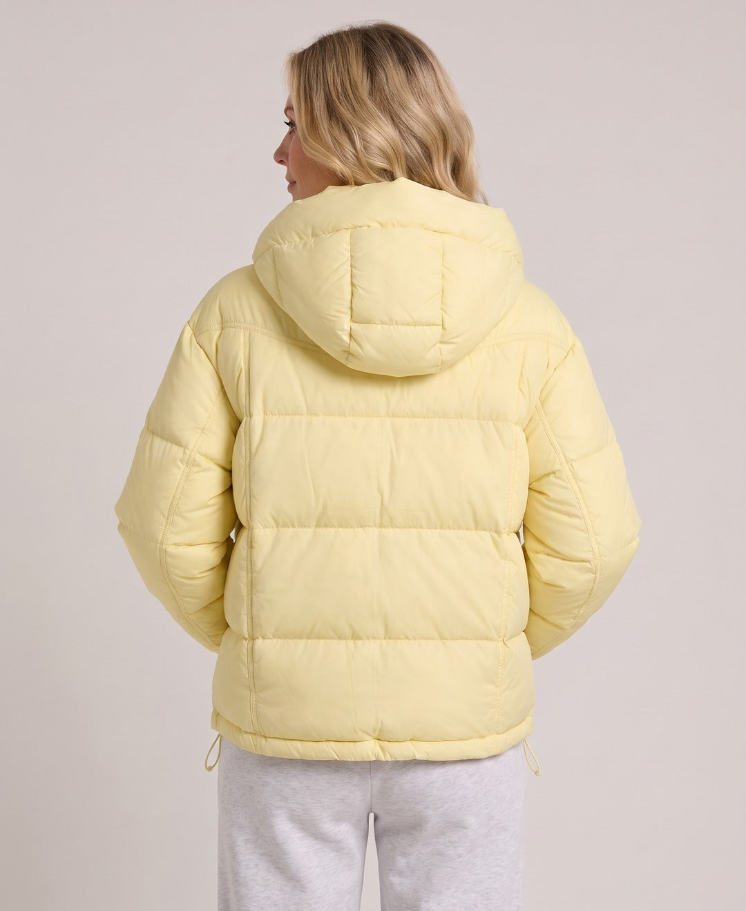 Women's Short Puffer Jacket Stand Collar Zip Front Drawstring Hem in Light Yellow, back view