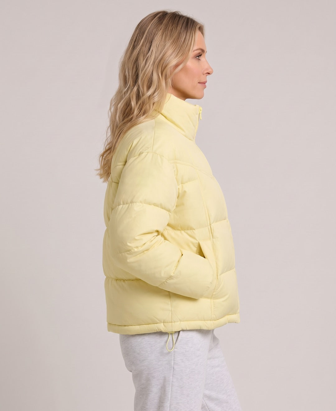 Women's Short Puffer Jacket Stand Collar Zip Front Drawstring Hem in Light Yellow, side view