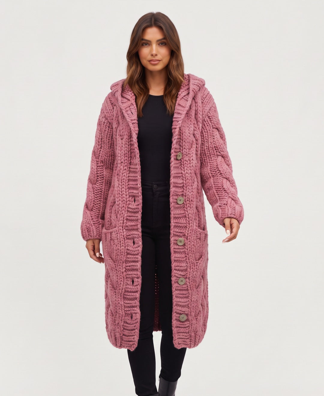 Women's long chunky cable knit hooded cardigan in pink, front view