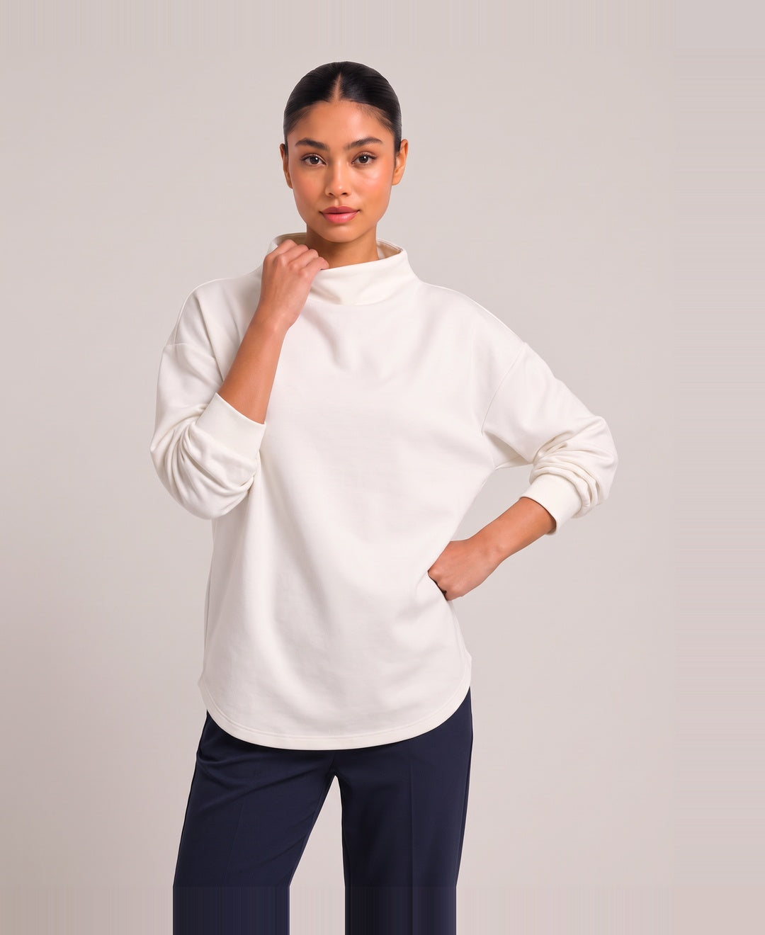 Women's oversized funnel neck top in white, front view